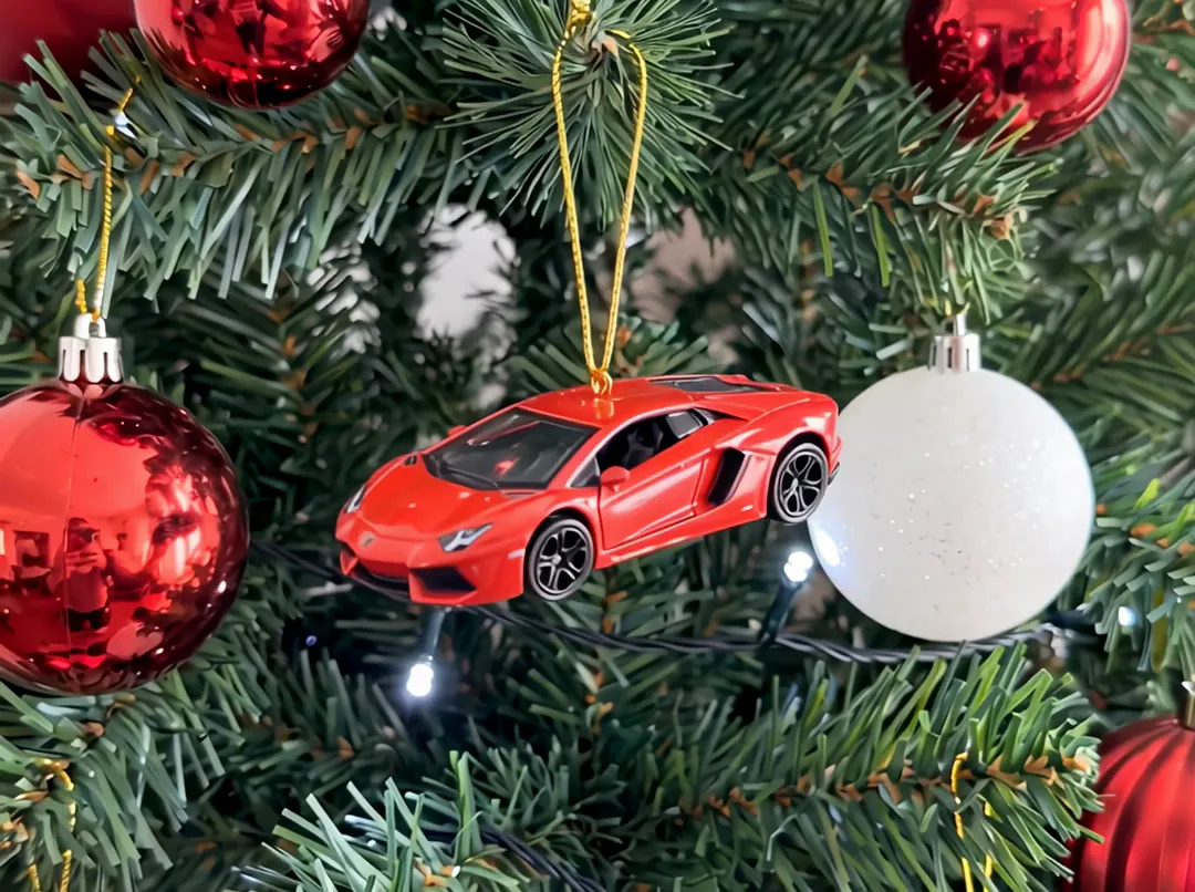 Red mini supercar hanging on a Christmas tree